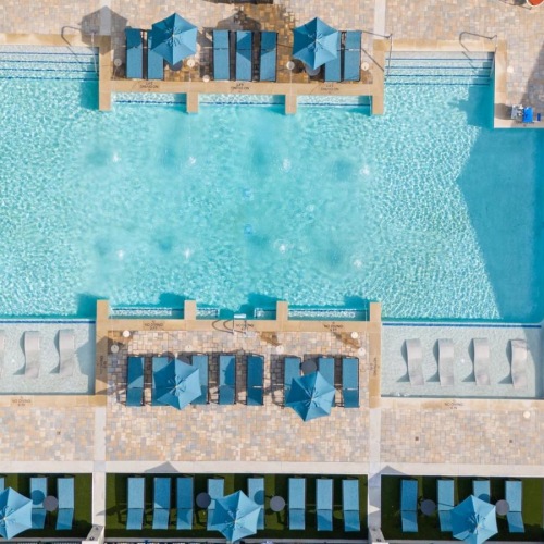 Resort-style swimming pool a building with a pool