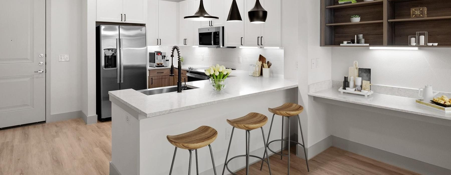 a kitchen with a bar stool and a bar stool