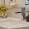 a vase of yellow flowers sits on a sink