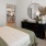 a bedroom with a bed and a mirror