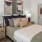 a bedroom with a bed and lamps