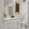 a bathroom with white cabinets